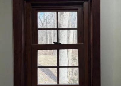 Newly installed wooden-framed bathroom window with countryside view