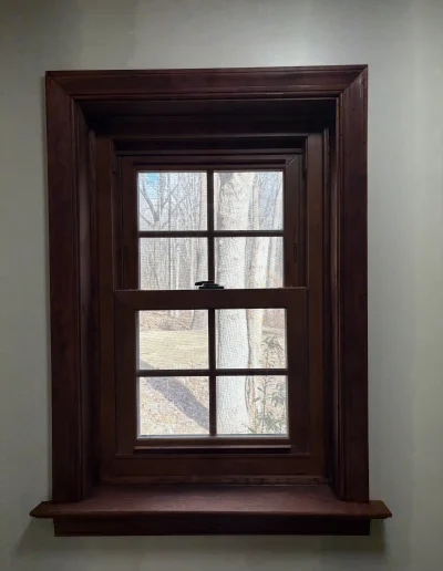 Newly installed wooden-framed bathroom window with countryside view