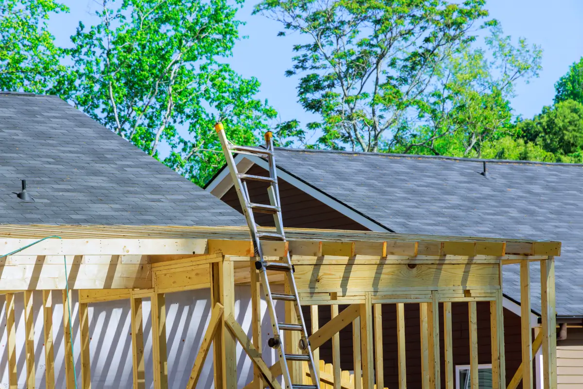 home-extension-preview Wooden frame and roofing under construction for a house extension.