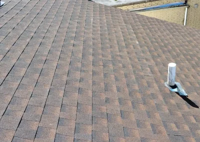 Close-up of a newly installed asphalt shingle roof showing even pattern and clean finish.