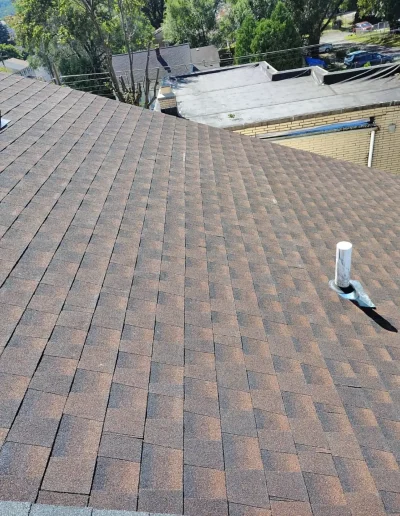 Close-up of a newly installed asphalt shingle roof showing even pattern and clean finish.