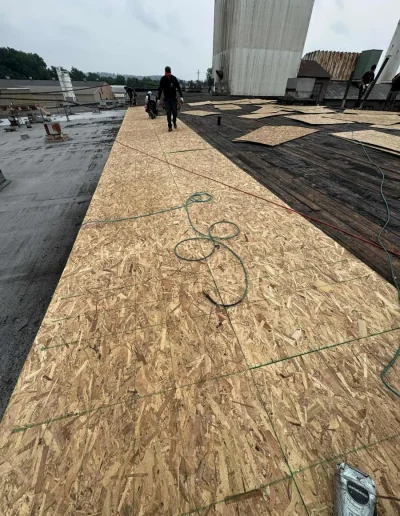 Commercial roof redecking with new plywood sheets installed for a stable, durable base before waterproof membrane application.