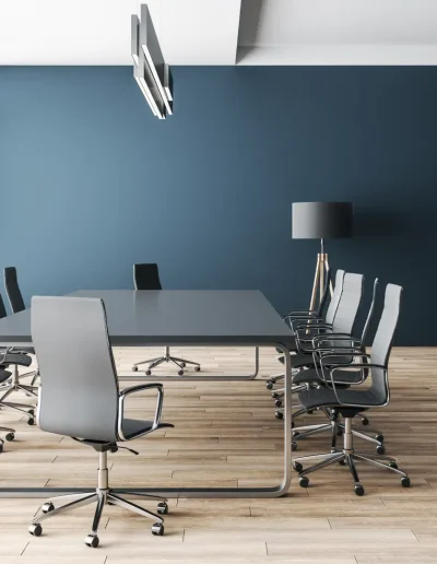 Modern conference room with floor-to-ceiling windows, sleek black chairs, a long meeting table, wooden flooring, blue walls, and minimalist shelving.