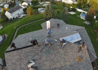 Roof repair crew working on ridge